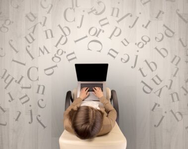 Lettres avec une femme utilisant un ordinateur portable sur une chaise